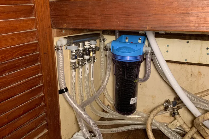 Slide: The Image of Plumbing system in a 1972 Tartan 41 sailboat with water filter and hoses. - 55