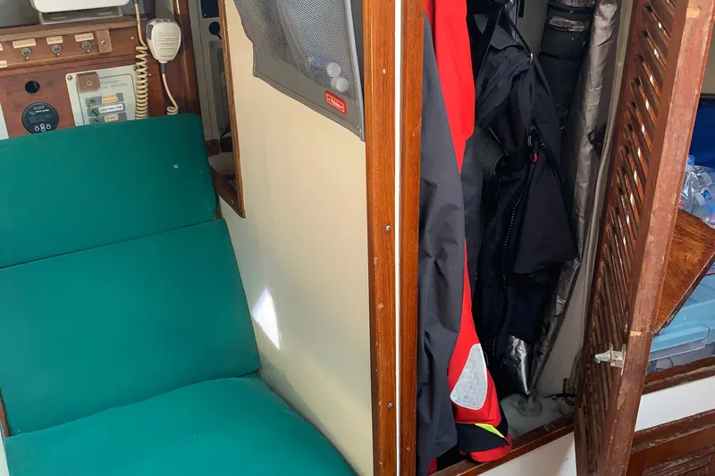 Slide: The Image of Interior of a 1972 Tartan 41 sailboat with green seating and storage area. - 61