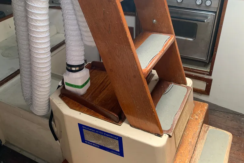 Slide: The Image of Interior of a 1972 Tartan 41 sailboat with wooden steps and ventilation ducts. - 62