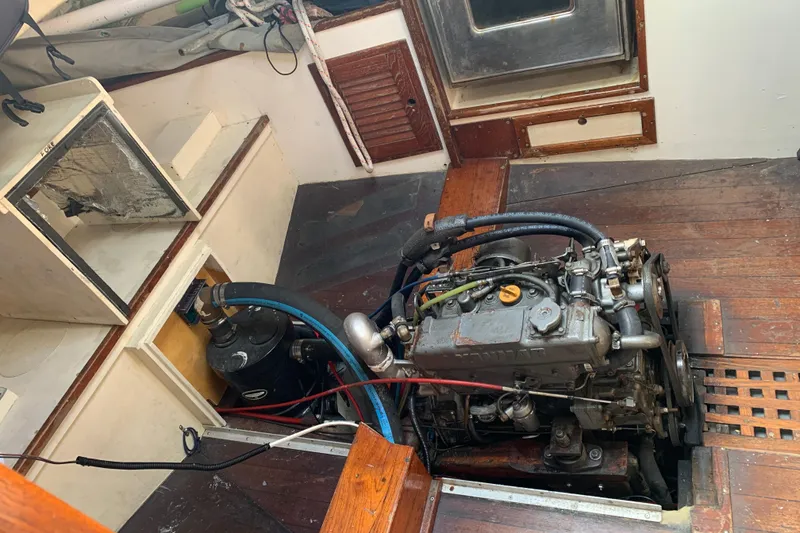 Slide: The Image of Engine compartment of a 1972 Tartan 41 sailboat, showcasing mechanical components and wooden interior. - 63