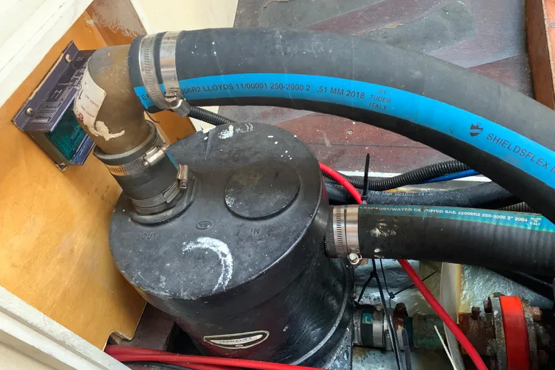 Slide: The Image of Engine compartment of a 1972 Tartan 41 sailboat with hoses and fittings. - 65