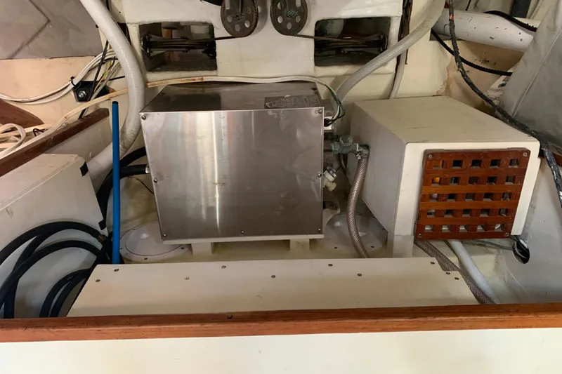 Slide: The Image of Engine compartment of a 1972 Tartan 41 sailboat, featuring mechanical components and wiring. - 68