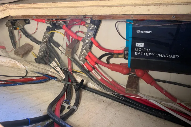 Slide: The Image of Electrical wiring and Renogy DC-DC battery charger in a 1972 Tartan 41 boat. - 70