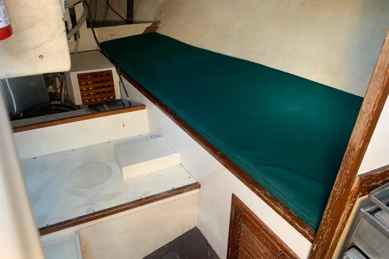 Slide: The Image of Interior of a 1972 Tartan 41 sailboat with green cushioned berth. - 75