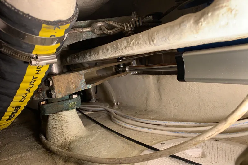 Slide: The Image of Engine compartment of a 1972 Tartan 41 sailboat, showing exhaust hose and mechanical components. - 76