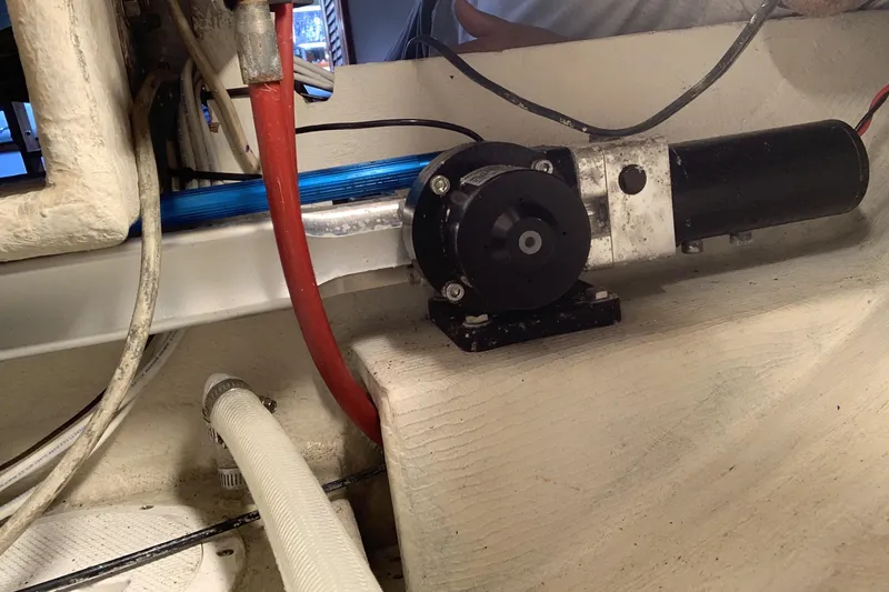 Slide: The Image of Engine compartment of a 1972 Tartan 41 sailboat, featuring mechanical components and wiring. - 77