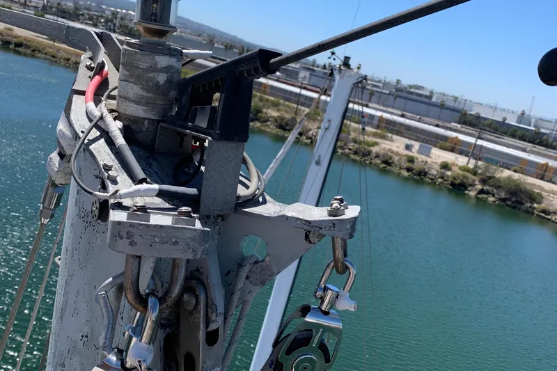 Slide: The Image of Close-up of a 1972 Tartan 41 sailboat mast with rigging over water. - 79