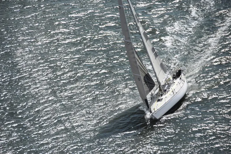 Slide: The Image of Vintage 1972 Tartan 41 sailboat navigating sparkling waters. - 8