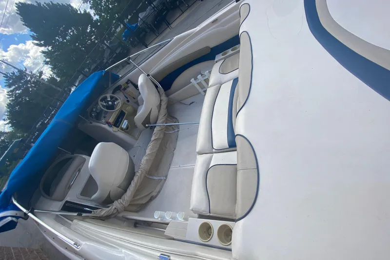 Slide: The Image of 1998 Glastron/Carlson GS225 boat interior with blue and white seating and steering area. - 5