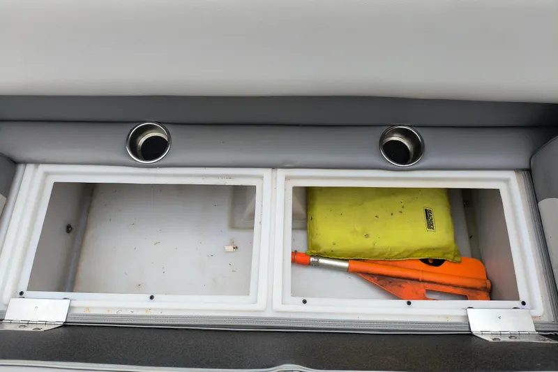 Slide: The Image of Storage compartments in 2025 SunCatcher Select 324RC boat, containing safety equipment and accessories. - 12