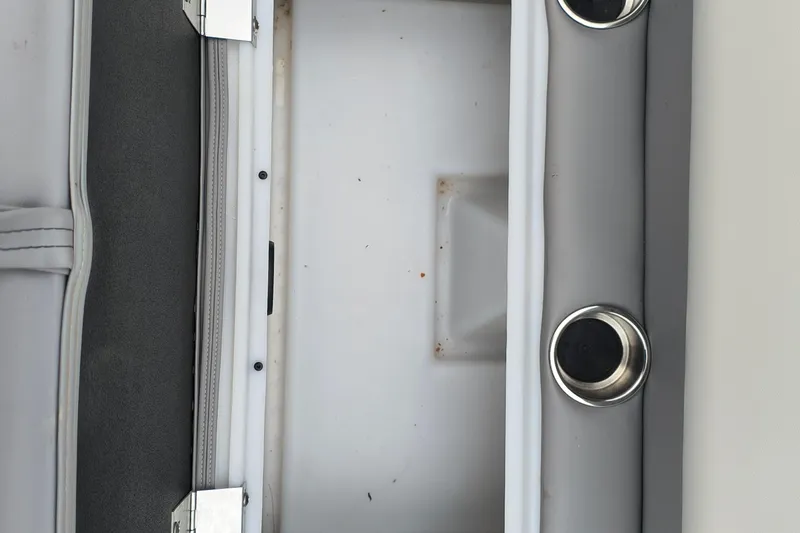Slide: The Image of Interior view of 2025 SunCatcher Select 324RC boat with cup holders and storage compartment. - 17