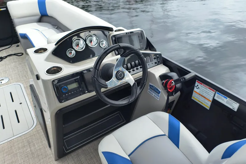Slide: The Image of 2025 SunCatcher Select 324RC boat interior with steering wheel and control panel. - 20
