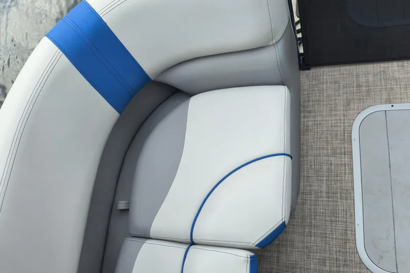 Slide: The Image of 2025 SunCatcher Select 324RC boat interior with white and blue cushioned seating. - 27