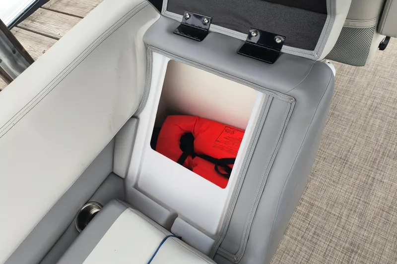 Slide: The Image of Open storage compartment in 2025 SunCatcher Select 324RC boat with life jacket inside. - 31