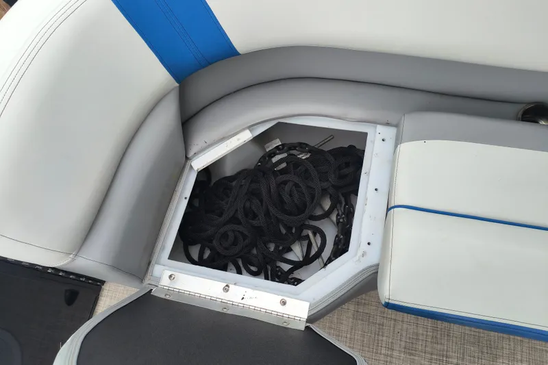 Slide: The Image of Storage compartment in 2025 SunCatcher Select 324RC boat with ropes and chains. - 35