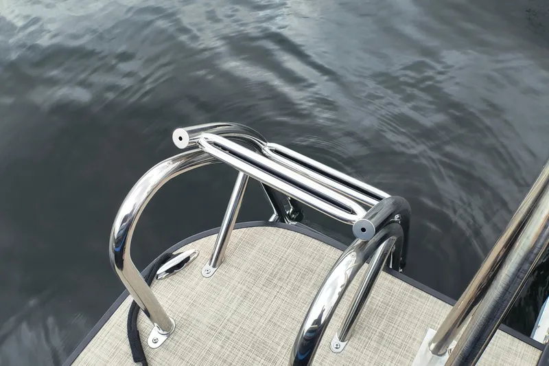 Slide: The Image of Stainless steel boat ladder on 2025 SunCatcher Select 324RC, above calm water. - 37