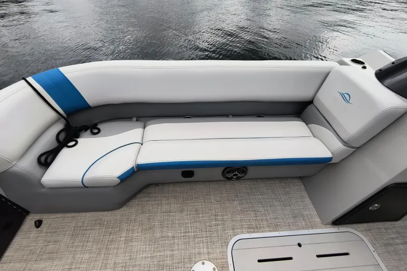 Slide: The Image of 2025 SunCatcher Select 324RC boat interior with white and blue cushioned seating. - 9