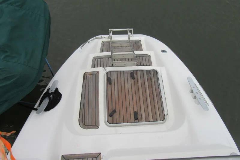 Slide: The Image of Catana 471 yacht deck, 2001 model, featuring teak wood finish and ladder. - 10