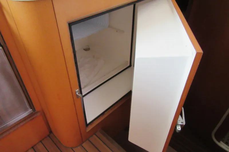 Slide: The Image of Open storage compartment on 2001 Catana 471 yacht, featuring wooden interior design. - 105