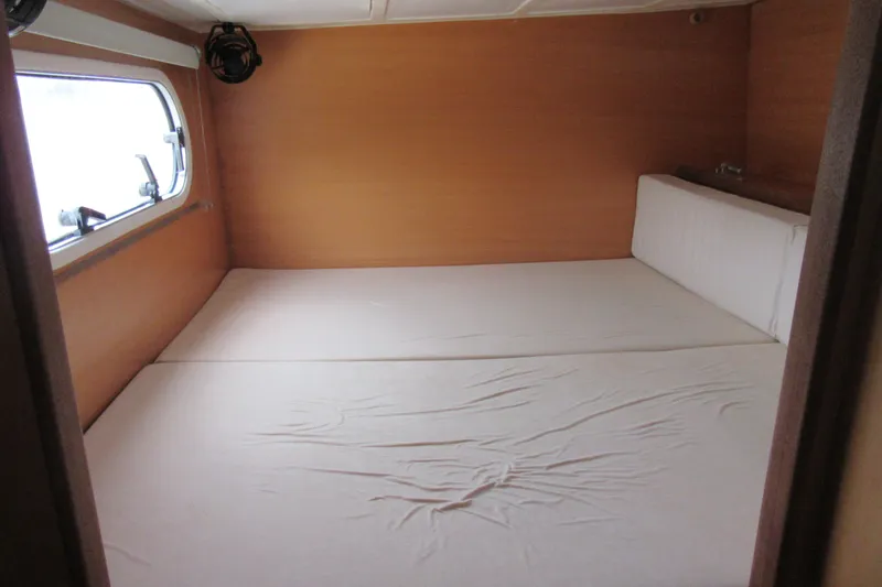 Slide: The Image of Interior cabin of 2001 Catana 471 yacht with a spacious bed and window. - 110
