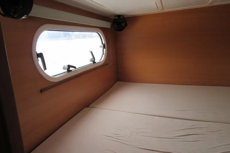 Slide: The Image of Interior cabin of 2001 Catana 471 yacht with window and bed. - 112