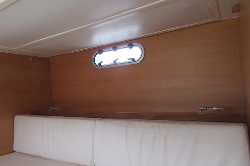 Slide: The Image of Interior of 2001 Catana 471 yacht with wooden paneling and cushioned seating. - 113