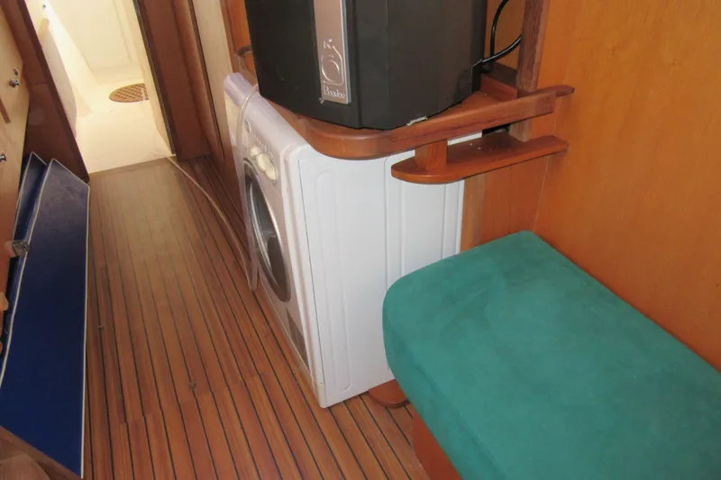 Slide: The Image of Interior of 2001 Catana 471 yacht with washing machine and wooden flooring. - 116