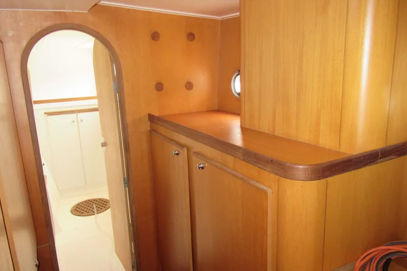 Slide: The Image of Interior of 2001 Catana 471 yacht with wooden cabinetry and porthole. - 117