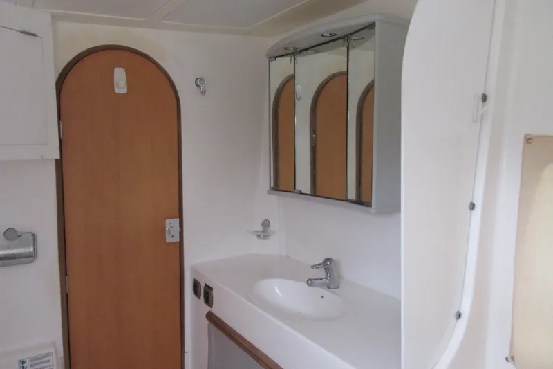Slide: The Image of Bathroom interior of 2001 Catana 471 yacht with sink and mirrored cabinet. - 124
