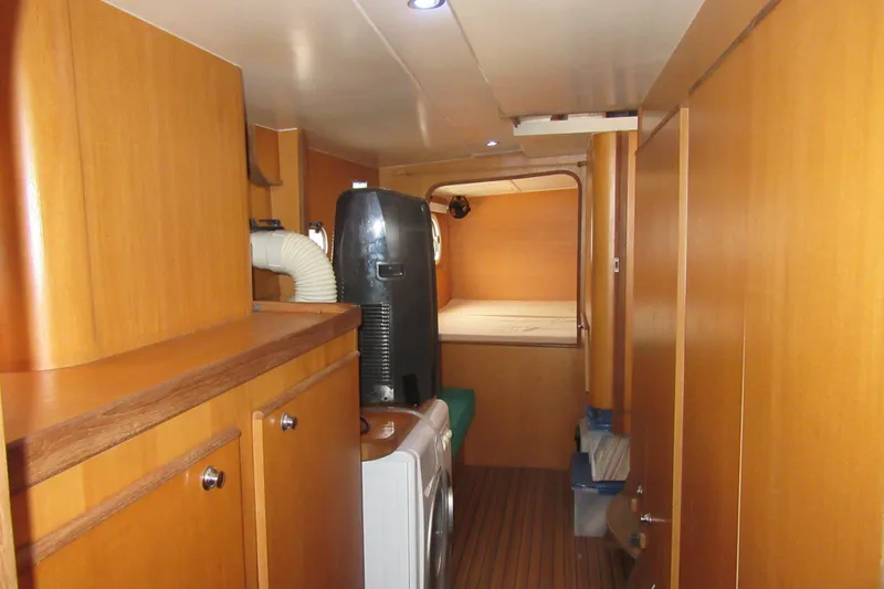 Slide: The Image of Interior of 2001 Catana 471 yacht with wooden cabinetry and compact living space. - 128