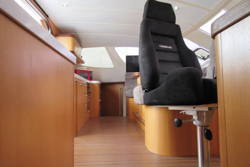 Slide: The Image of Interior of 2001 Catana 471 yacht with modern seating and wooden cabinetry. - 131