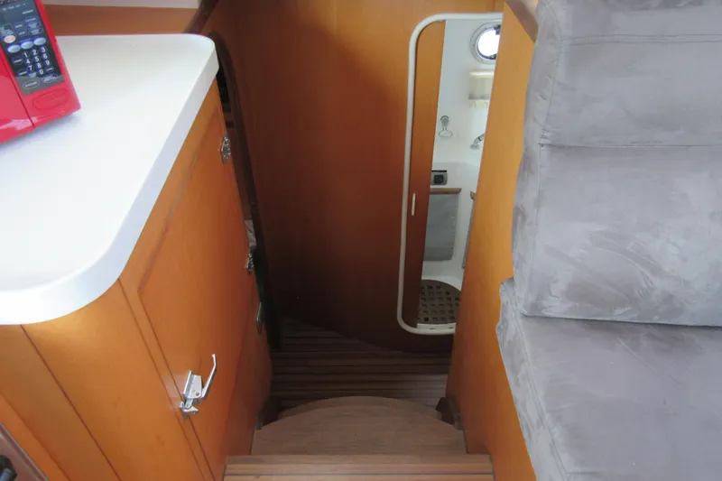 Slide: The Image of Interior of 2001 Catana 471 yacht showing stairs, cabinetry, and bathroom entrance. - 135