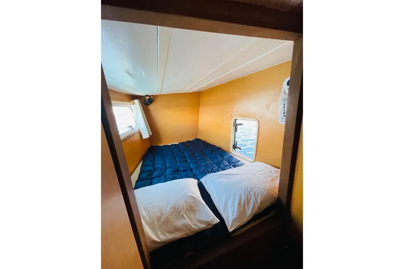 Slide: The Image of Cozy cabin interior of 2001 Catana 471 yacht with bed and window view. - 136