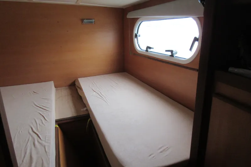 Slide: The Image of Interior cabin of 2001 Catana 471 yacht with twin beds and window. - 138