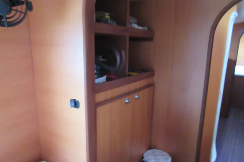 Slide: The Image of Interior of 2001 Catana 471 yacht with wooden cabinetry and shelving. - 143