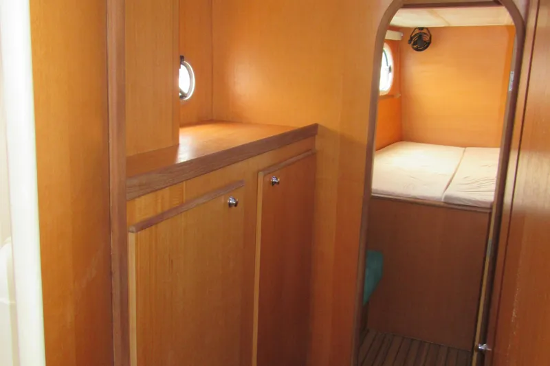 Slide: The Image of Interior cabin of 2001 Catana 471 yacht with wooden finish and cozy bed. - 145