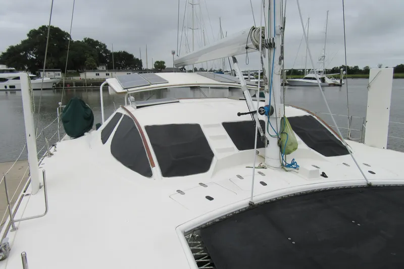 Slide: The Image of Catana 471 catamaran from 2001 docked at a marina, featuring solar panels. - 15