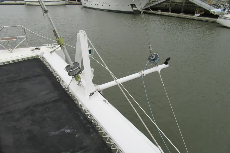 Slide: The Image of Catana 471 catamaran deck view, showcasing rigging and netting, docked in marina. - 16