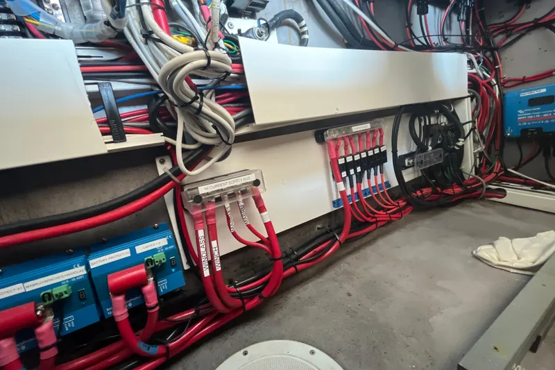 Slide: The Image of Electrical wiring system inside a 2001 Catana 471 yacht, featuring organized cables and components. - 160