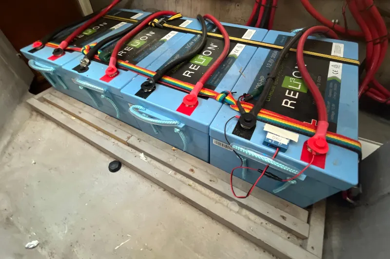 Slide: The Image of Lithium batteries in a 2001 Catana 471 yacht, connected with red and black cables. - 162