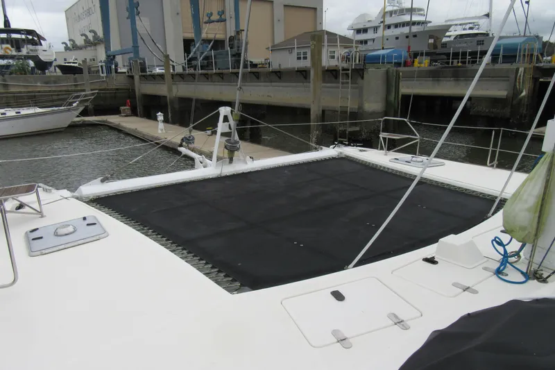 Slide: The Image of Catana 471 catamaran from 2001 docked at a marina, featuring a spacious deck. - 17
