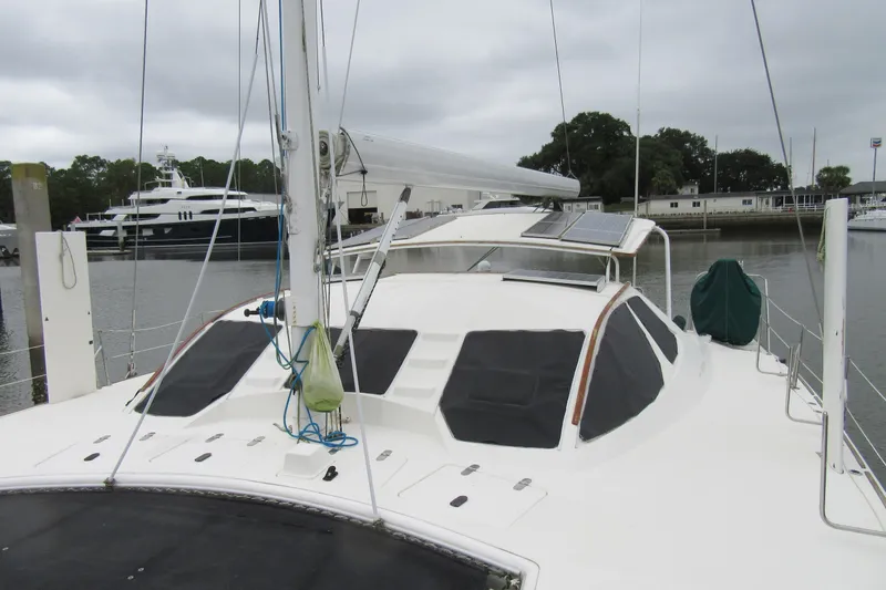 Slide: The Image of 2001 Catana 471 catamaran docked, featuring solar panels and sleek design. - 20