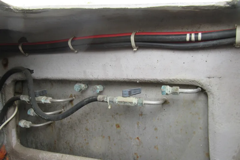Slide: The Image of Wiring and plumbing inside a 2001 Catana 471 boat, showing cables and pipes. - 26