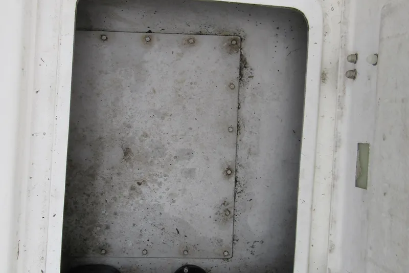 Slide: The Image of Interior compartment of a 2001 Catana 471, showing a metal panel with bolts. - 29