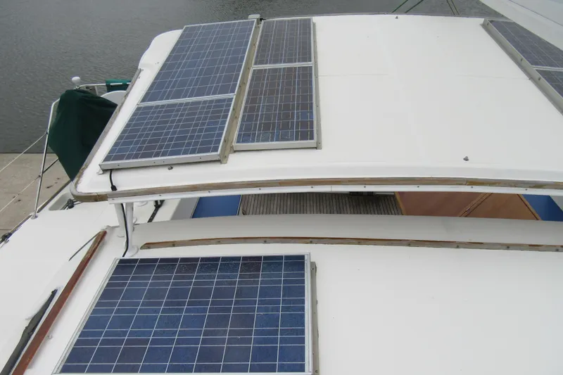 Slide: The Image of Solar panels on 2001 Catana 471 catamaran, docked by the water. - 31