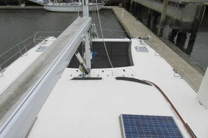 Slide: The Image of 2001 Catana 471 catamaran deck with solar panel, docked at marina. - 32
