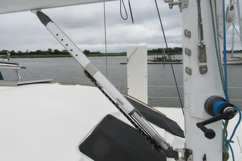 Slide: The Image of Catana 471 sailboat deck view, featuring rigging and equipment, docked by a calm river. - 36