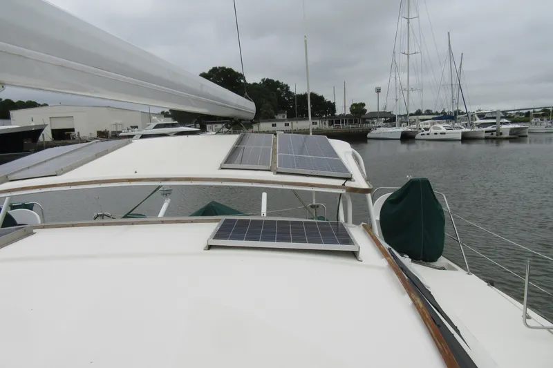 Slide: The Image of Catana 471 sailboat from 2001 with solar panels, docked in a marina. - 39
