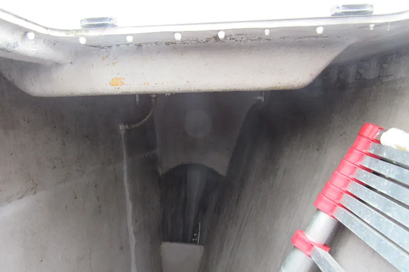 Slide: The Image of Interior view of a 2001 Catana 471 yacht, featuring a ladder and storage compartment. - 44