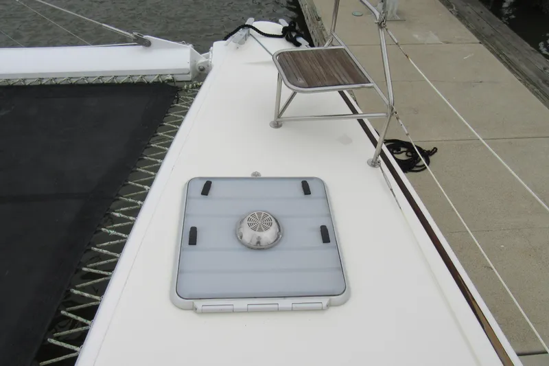 Slide: The Image of Deck of 2001 Catana 471 catamaran with hatch and seating near dock. - 45